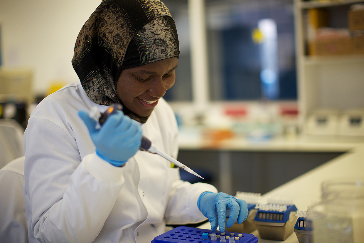 A woman working with samples in a pathology lab