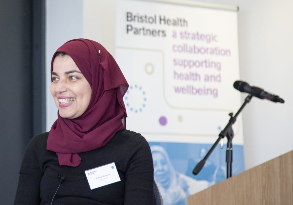 Woman standing next to lectern